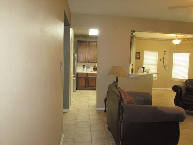 tiled living room with ceiling fan