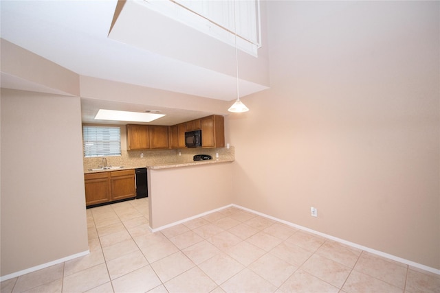 kitchen featuring sink, tasteful backsplash, hanging light fixtures, light tile patterned floors, and black appliances