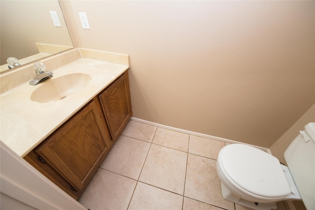 bathroom featuring vanity, tile patterned floors, and toilet