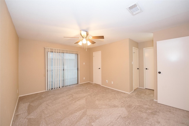 unfurnished room featuring light colored carpet and ceiling fan