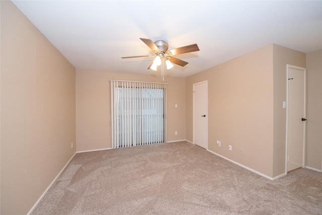 carpeted spare room with ceiling fan