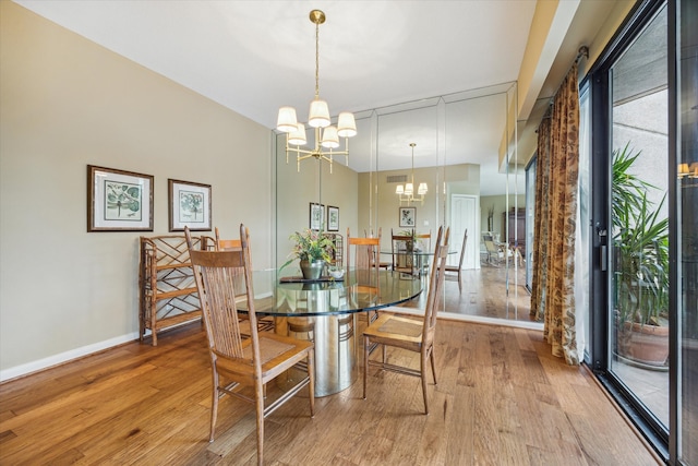 dining space with a chandelier and light wood-type flooring