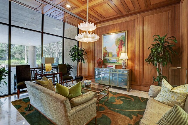 living room with wooden walls, wood ceiling, expansive windows, a chandelier, and coffered ceiling