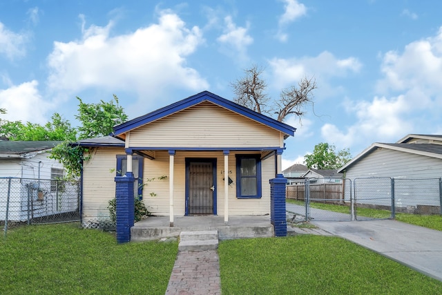 bungalow-style house featuring a porch and a front lawn