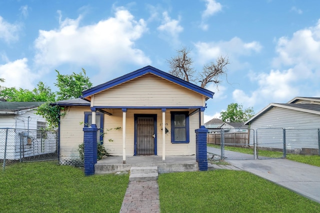 view of front of property with a porch, driveway, a front lawn, and a gate