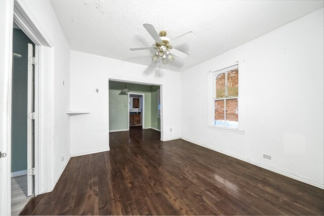 empty room with a textured ceiling, hardwood / wood-style floors, and ceiling fan