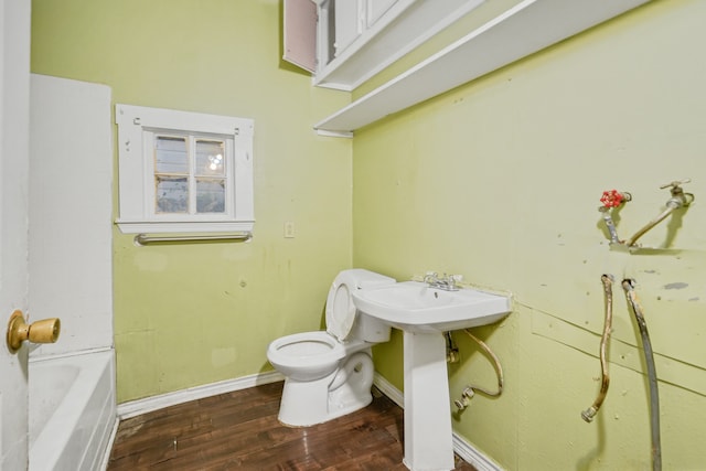 bathroom with sink, toilet, and hardwood / wood-style flooring