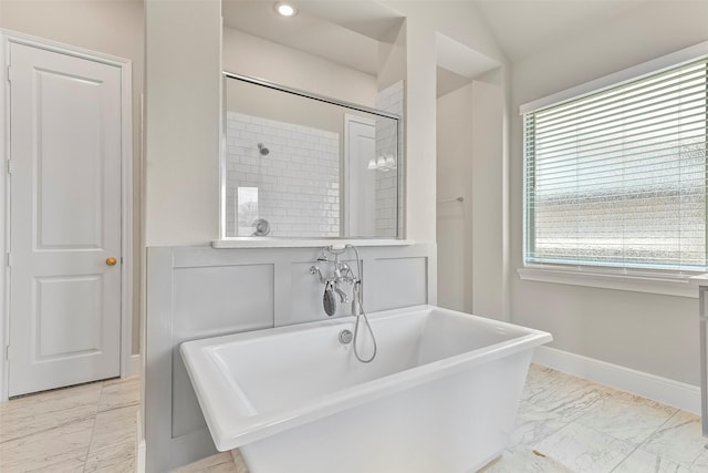 bathroom featuring tile patterned flooring, a bath, and plenty of natural light