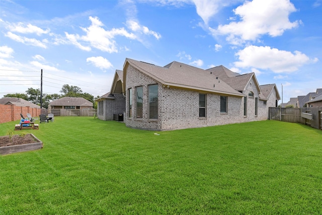 rear view of property featuring a yard