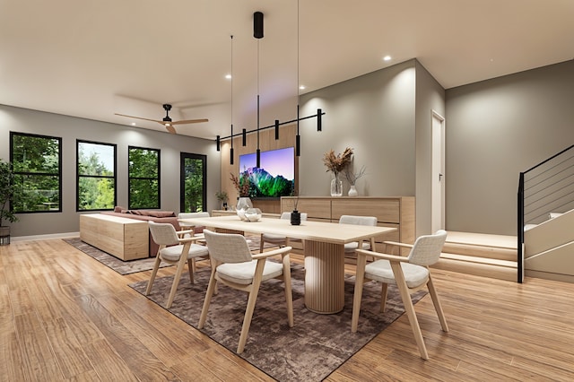 dining space with light wood-type flooring and ceiling fan