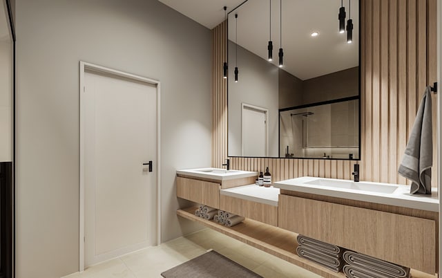 bathroom with tile patterned flooring, vanity, and a shower with door