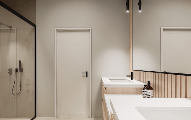 bathroom featuring tile patterned flooring, vanity, and walk in shower