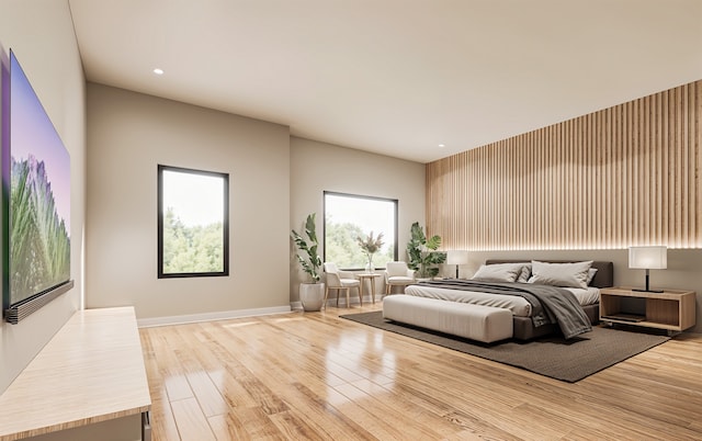 bedroom with light hardwood / wood-style flooring and multiple windows