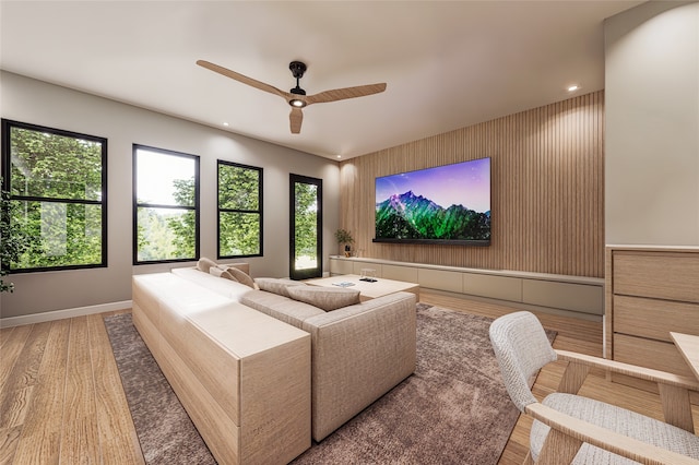 home theater with hardwood / wood-style floors and ceiling fan