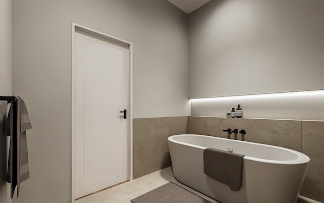 bathroom with a bathing tub and tile walls