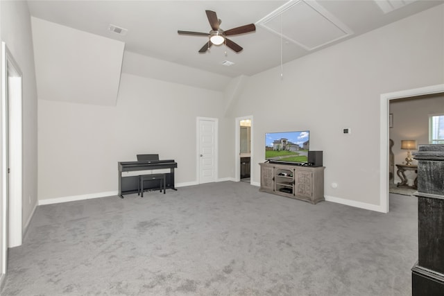 unfurnished living room with carpet flooring, high vaulted ceiling, and ceiling fan