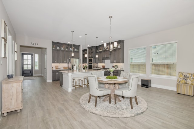 dining room featuring a notable chandelier and light wood-type flooring