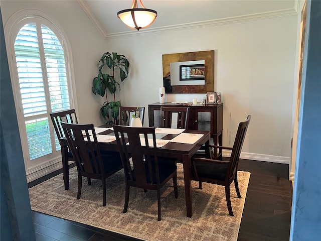 dining space with crown molding and hardwood / wood-style flooring