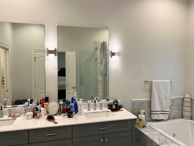 bathroom featuring vanity and shower with separate bathtub