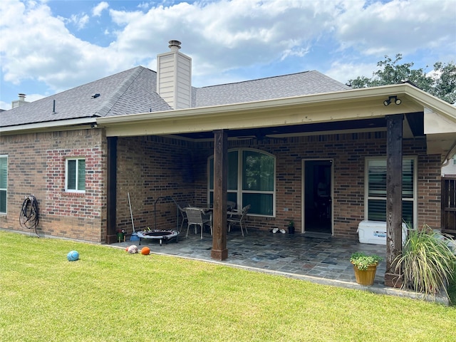 rear view of house with a patio area and a yard