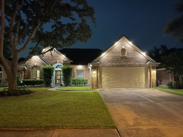 single story home with a lawn and a garage