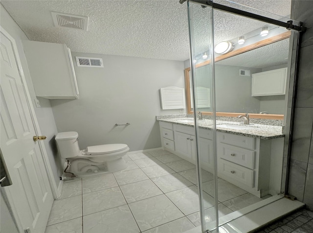 bathroom with a textured ceiling, vanity, toilet, and a shower with shower door