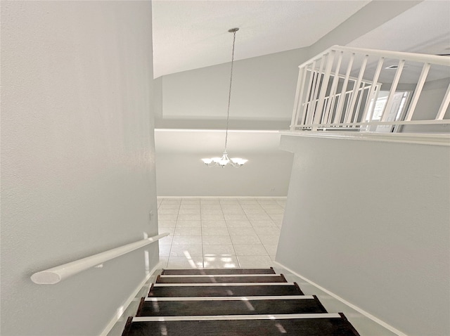 staircase featuring an inviting chandelier, lofted ceiling, and tile patterned floors