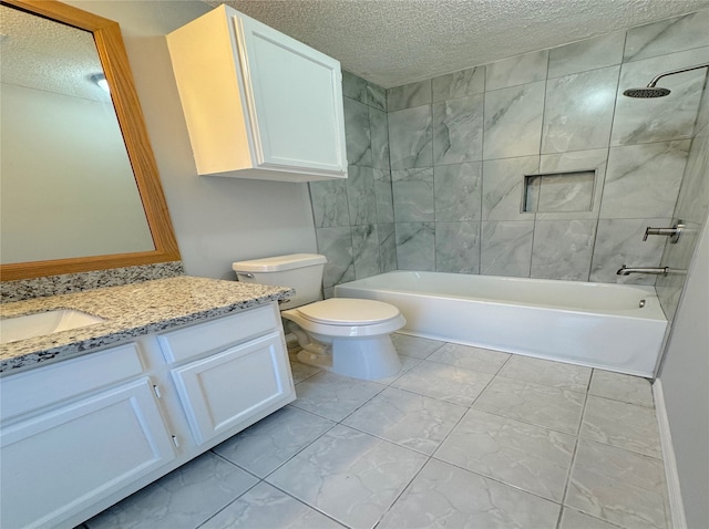 full bathroom with a textured ceiling, tiled shower / bath combo, vanity, and toilet