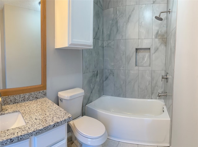 full bathroom featuring tiled shower / bath, vanity, toilet, and tile patterned floors