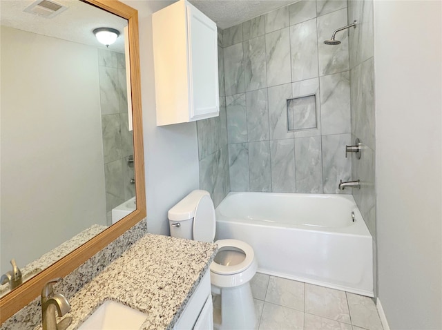 full bathroom with vanity, a textured ceiling, tiled shower / bath combo, tile patterned flooring, and toilet