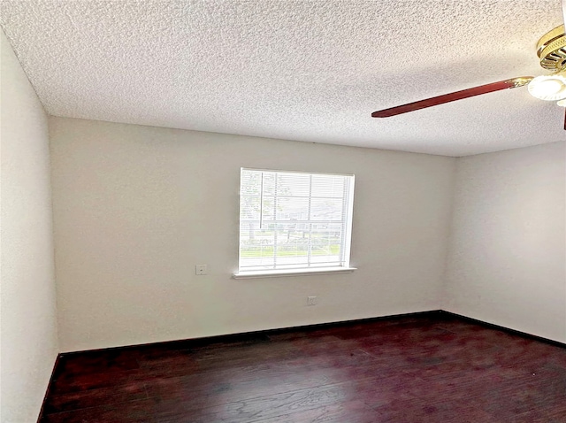 spare room with ceiling fan, a textured ceiling, and dark hardwood / wood-style floors