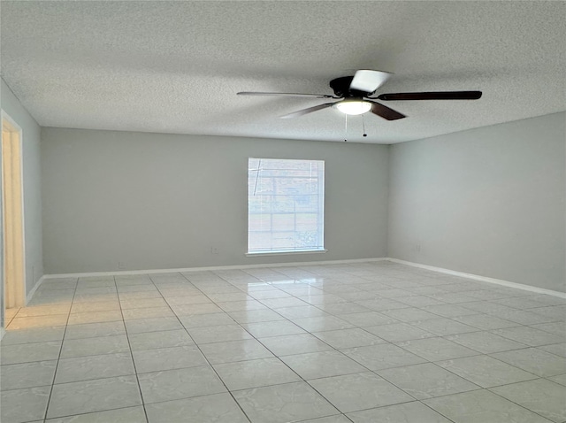 tiled empty room with ceiling fan and a textured ceiling