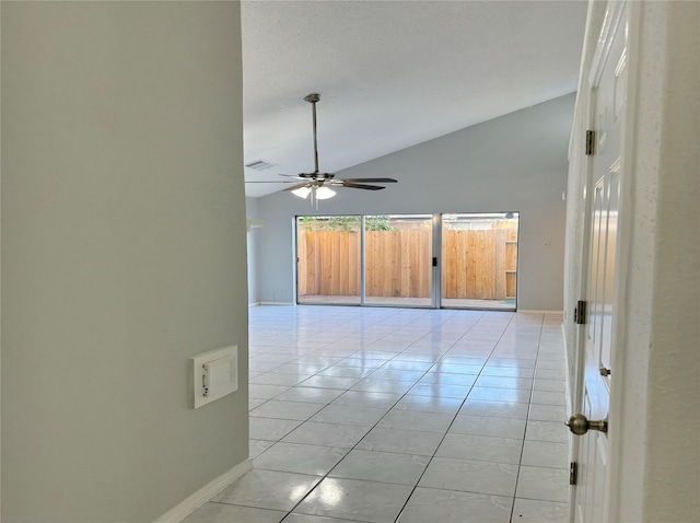 empty room featuring light tile patterned floors, ceiling fan, and high vaulted ceiling