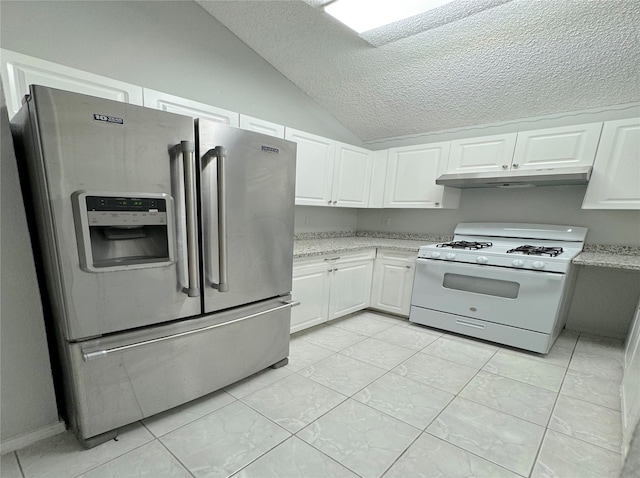 kitchen with white cabinets, lofted ceiling, stainless steel fridge, and white gas range oven