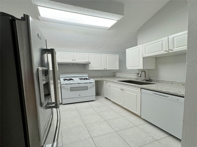 kitchen with white cabinets, white appliances, a textured ceiling, and sink