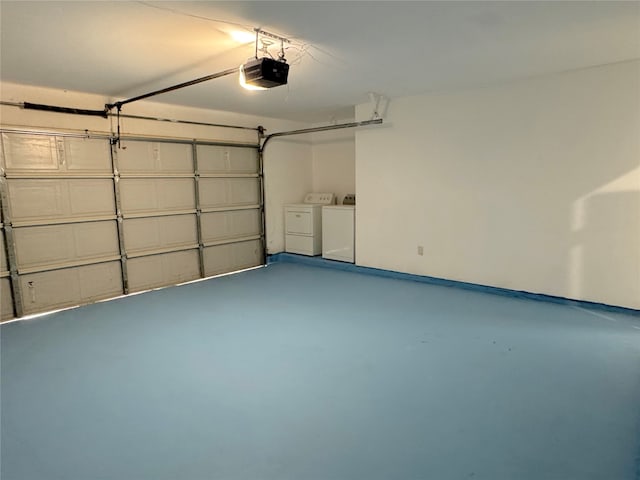 garage with a garage door opener and washer and clothes dryer