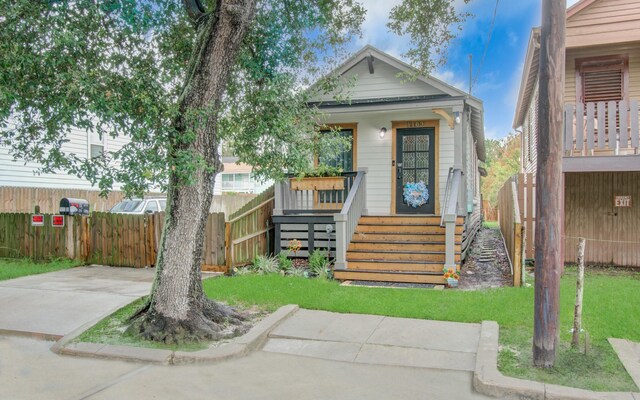 bungalow with a front lawn