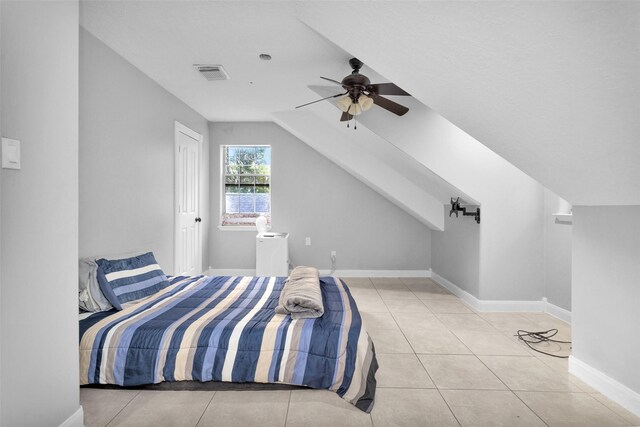 tiled bedroom with vaulted ceiling and ceiling fan