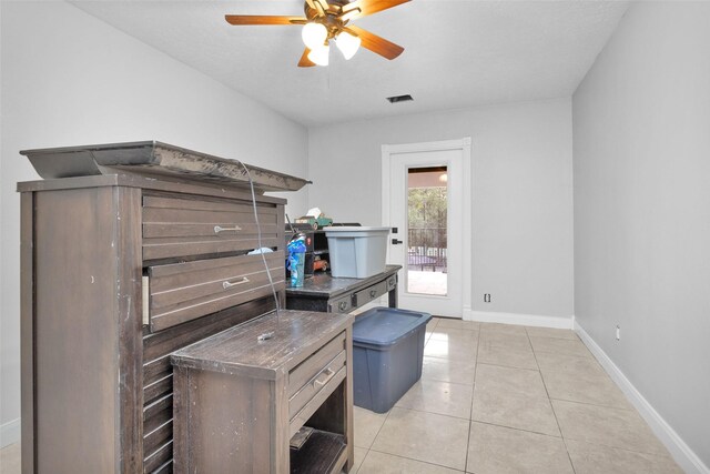 office with ceiling fan and light tile patterned floors