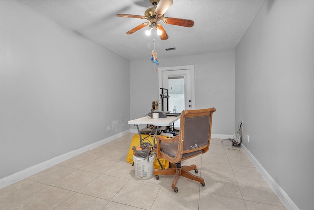 dining area featuring a textured ceiling, light tile patterned floors, and ceiling fan