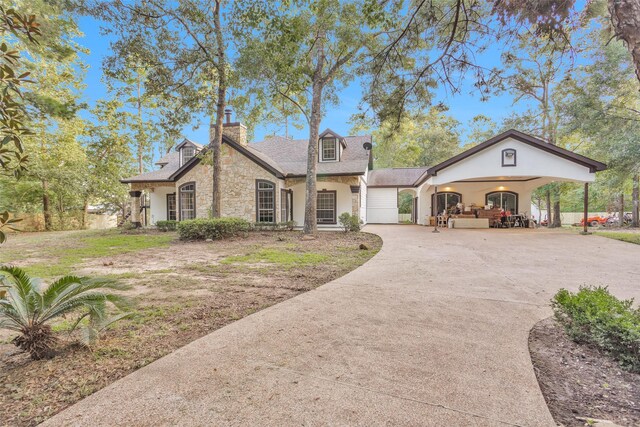 view of front of property with a garage and a carport