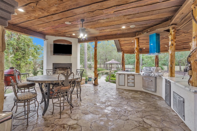 view of patio with a gazebo, exterior kitchen, and a grill