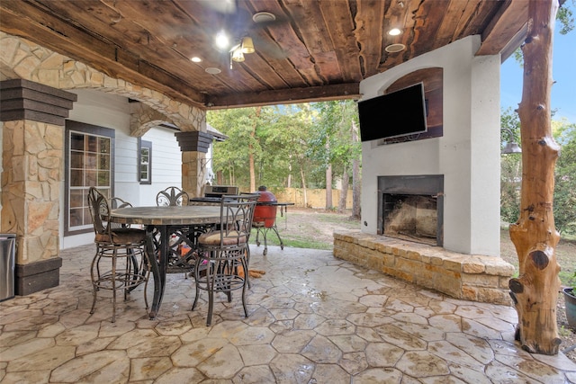 view of patio with an outdoor fireplace