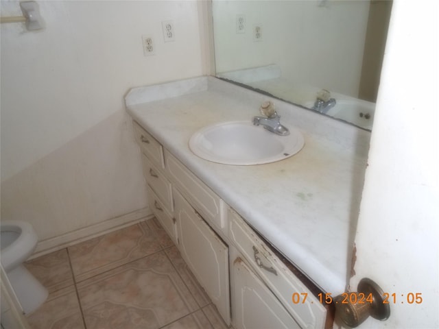 bathroom with tile patterned floors and vanity