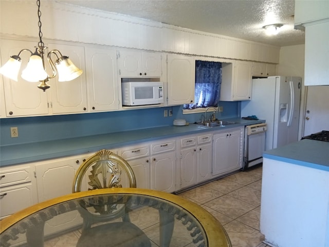 11807 Martin Luther King, Houston, TX 77048 - kitchen with white appliances, a textured ceiling, a chandelier, white cabinets, and light tile patterned flooring