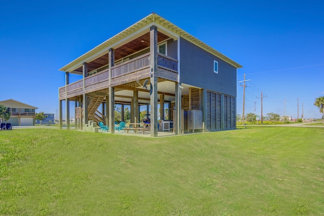 rear view of property featuring a patio area and a lawn