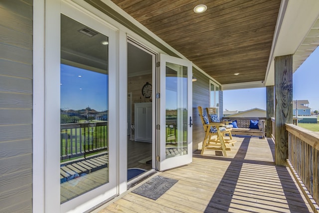 wooden terrace featuring visible vents