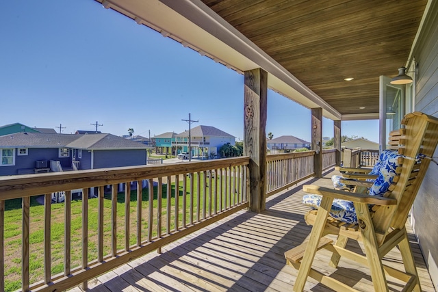 wooden deck with a lawn and a residential view