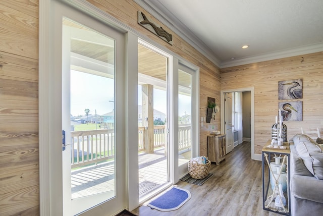 doorway with wood walls and hardwood / wood-style floors