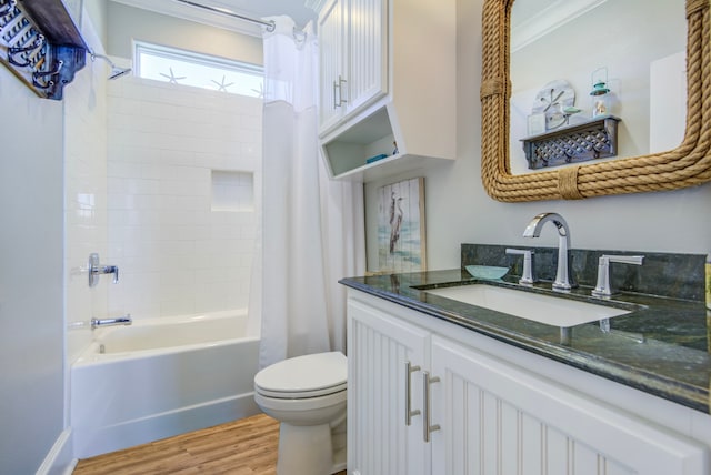 full bathroom featuring toilet, shower / bath combination with curtain, hardwood / wood-style floors, crown molding, and vanity